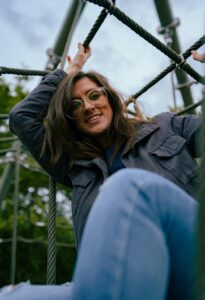 Woman with glasses on climbing ropes outdoors